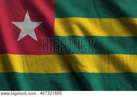 Togo Flag With Big Folds Waving Close Up Under The Studio Light Indoors. The Official Symbols And Co