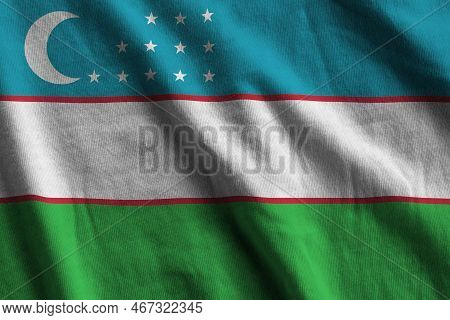 Uzbekistan Flag With Big Folds Waving Close Up Under The Studio Light Indoors. The Official Symbols 