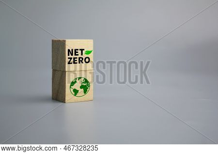 Wooden Cube With Earth Icon And Word Net Zero. The Natural Environment Is A Carbon Neutral And Net Z