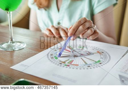 Tver, Russia - August 2, 2021. A Woman In A Cafe At A Table Is Studying The Design Of A Person. The 