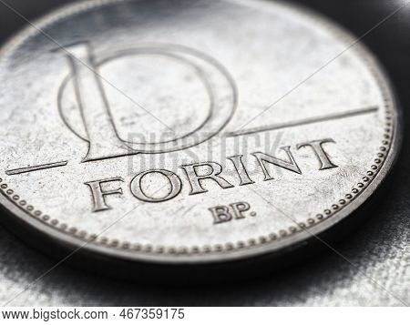 Hungarian Coin Of 10 Forints Lies On Textured Surface Closeup. Money Of Hungary. News About Economy 