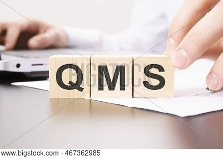 Wooden Blocks With Qms Text - On Table Background. Financial, Marketing And Business Concepts