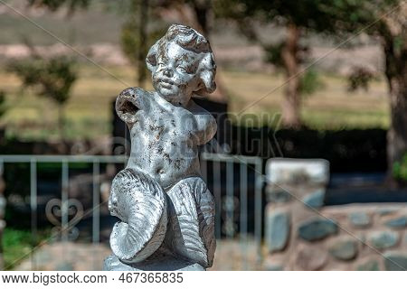 La Poma, Argentina - April 11, 2022: Damaged Statue Of A Child In The Square