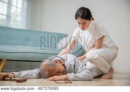 Asia Young Woman Halping Her Father After Falling Down On Floor, Elderly Old Man With Walking Stick 
