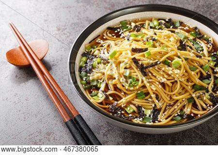 Memil Guksu Cold Soba Noodles Soup With Seaweed, Green Onions And Sesame Seeds Closeup In The Bowl O