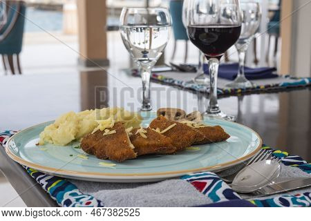 Stuffed Chicken Panne A La Carte Meal With Mushrooms And Mashed Potato At Restaurant Table Setting