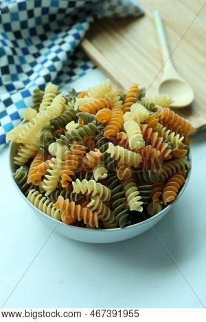 Vertical Shot Of Colorful Uncooked Pasta In A Bowl