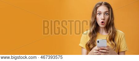 Close-up Shot Of Impressed Astonished Cute Young Girl With Makeup On And Natural Wavy Hair Folding L