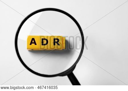 Alternative Dispute Resolution. Top View Through Magnifying Glass On Yellow Cubes With Letters Adr, 