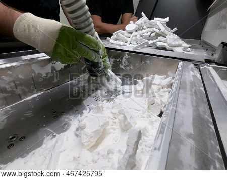 Mane Taking Out Models From White Polyamide Powder In Working Chamber Of 3d Printer, Cleaning And Re