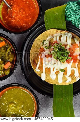 Taco Condesa With Fried Fish On Black Plate With Mexican Sauces