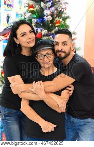Mexican Family Standing Together Against Christmas Tree