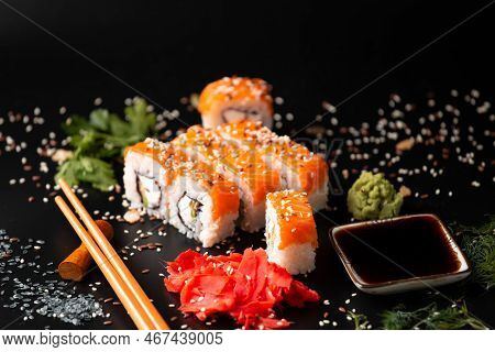 The Range Of Different Types Of Japanese Sushi And Rolls. On Dark Rustic Background. Rolls On A Dark