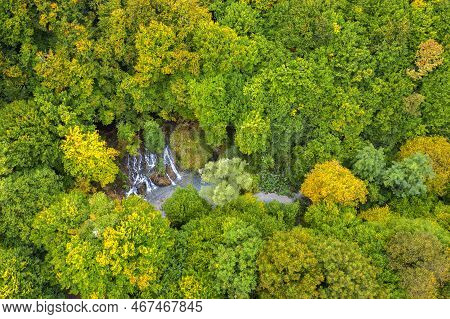 Aerial View From Drone Of Beauty Waterfall Between Trees In Autumn