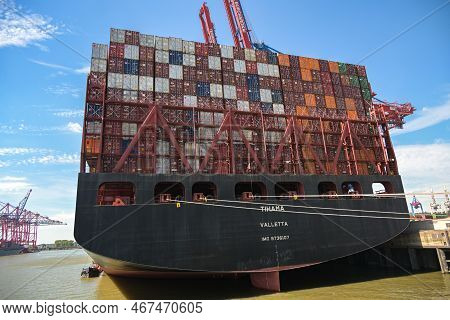Hamburg, Germany, August 3, 2022: Ultra Large Freighter Ship Tihama From Behind Full Of Stacked Cont