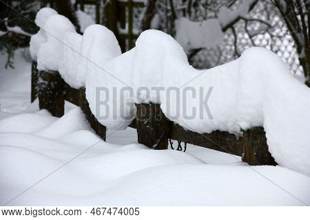 Fragment Of A Decorative Garden After A Heavy Snowfall. The Thick Layer Of Fluffy Snow Repeats A Con