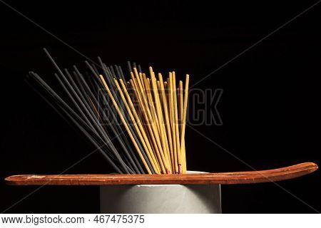 Many Different Incense Sticks With Wooden Stand