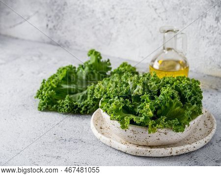 Green Kale Leaves In White Craft Bowl On Gray Cement Background. Healthy Eating, Vegetarian Food, Di