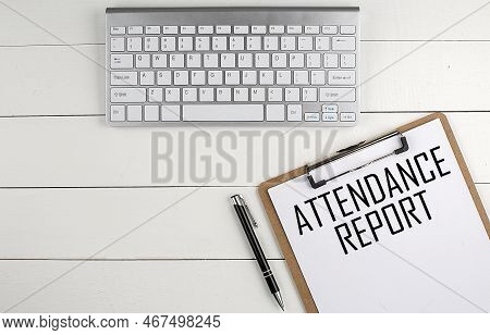 Home Office Workspace With Keyboard, Clipboard And Pen With Text Attendance Report On A White Wooden