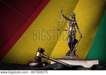 Guinea Flag With Statue Of Lady Justice, Constitution And Judge Hammer On Black Drapery. Concept Of 