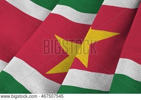 Suriname Flag With Big Folds Waving Close Up Under The Studio Light Indoors. The Official Symbols An