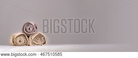 Close-up Of A Composition With Three Twisted Towels On A Massage Table In A Spa. Banner