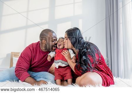 African Family, Nigerian Father, Asian Mother Holding And Kissing A 4-month-old Baby Newborn Son, Th
