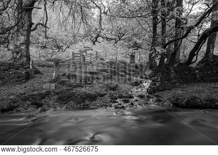 Long Exposure Of The Weir Water River Flowing Downstream Of Robbers Bridge In Exmoor National Park