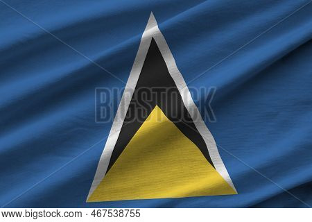 Saint Lucia Flag With Big Folds Waving Close Up Under The Studio Light Indoors. The Official Symbols