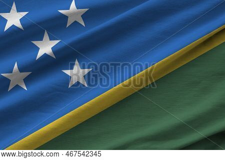 Solomon Islands Flag With Big Folds Waving Close Up Under The Studio Light Indoors. The Official Sym