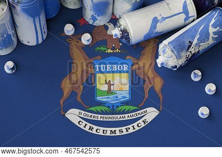 Michigan Us State Flag And Few Used Aerosol Spray Cans For Graffiti Painting. Street Art Culture Con
