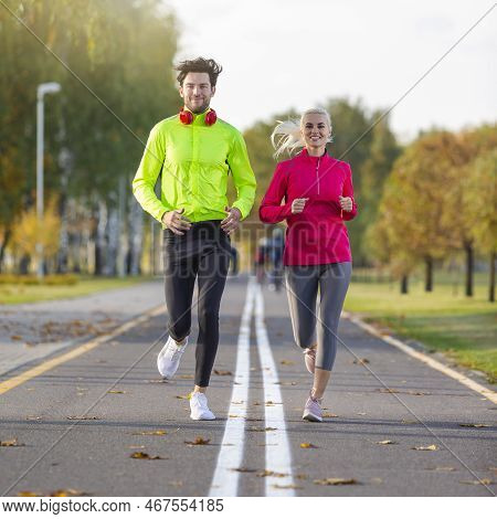 Sport Concepts. City Running Couple Happily Jogging Outside As Runners Training Outdoors Working Out
