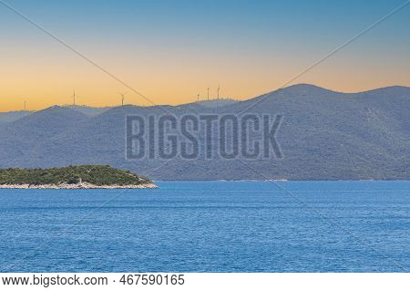 Seaside Landscape In The Peljesac Region Of Croatia. We See The Sea And Mountains And Wind Farms.