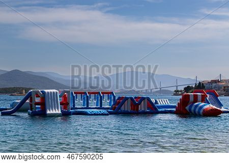 Water Attractions On The Sea By The Beach. In The Background Is The New Bridge On Peljesac In Croati