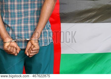 Arabian With Handcuffs On Flag Of United Arab Emiratesbackground. Back View. Concept Of Prisons And 