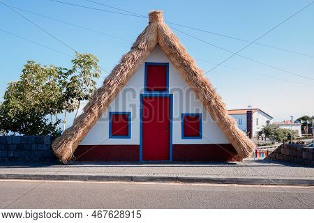 Santana, Madeira, Portugal - September 12, 2022: Typical Colorful House Of Santana Town With Thatche