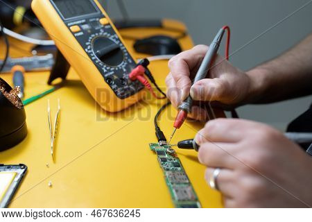 Smartphone Repair In A Service Center. Hands Of A Professional Master Repairman Repairing Disassembl