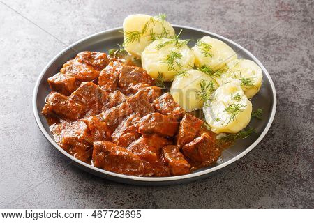 Viennese Beef Goulash With Thick Sauce Served With Boiled Potatoes Close-up On A Plate On The Table.