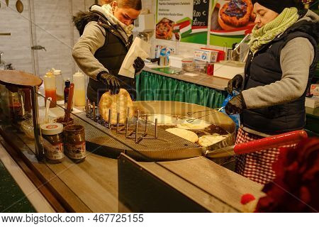 Dusselldorf, Germany - December 13, 2022: Women Preparing Langosh, A Traditional Hungarian Rich Flat