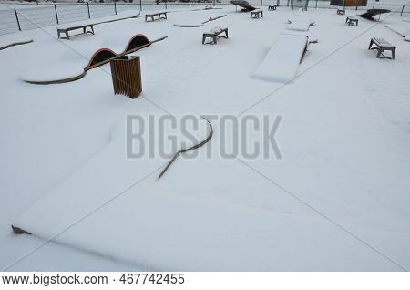 A Minigolf Course In The Park With Stainless Steel Obstacles And A Cobweb-shaped Ball Trap Into A Fu