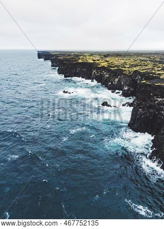 Vertical Photo Of Black Rocky Volcanic West Coast Of Iceland