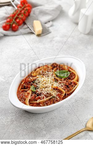 Pasta Stuffed With Bolognese Meat Sauce, Tomatoes, Cheese, Basil In Baking Dish. Italian Bolognese P