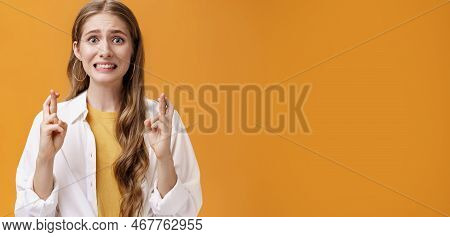 Girl Hopes She Did Well On Exam Clenching Teeth Looking Worried And Concerned, Crossing Fingers For 