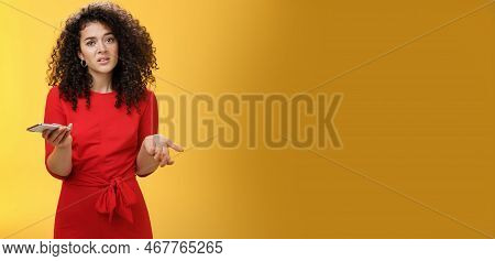 So Waht, I Confused. Questioned Uncertain Woman With Curly Hair In Red Dress Shrugging Looking Cluel