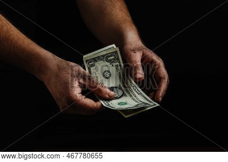 The Dirty Hands Of A Homeless Man, A Poor Man Holding Not Much Money, Dollars. The Concept Of Helpin