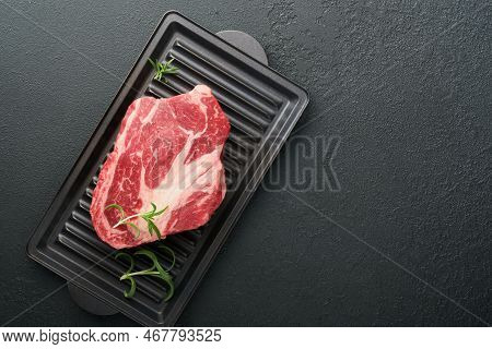 Raw Beef Steak. Raw Fresh Chuck Roll Steak With Rosemary, Salt And Pepper On Cutting Board On Dark C