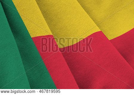 Benin Flag With Big Folds Waving Close Up Under The Studio Light Indoors. The Official Symbols And C
