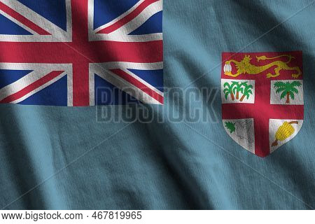 Fiji Flag With Big Folds Waving Close Up Under The Studio Light Indoors. The Official Symbols And Co