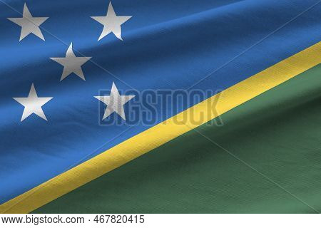 Solomon Islands Flag With Big Folds Waving Close Up Under The Studio Light Indoors. The Official Sym