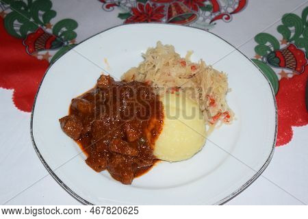 A Special Gulasch With German Dumpling And Sauerkraut As A Christmas Meal